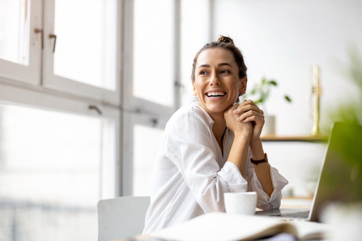 Business professional taking a phone call at her desk