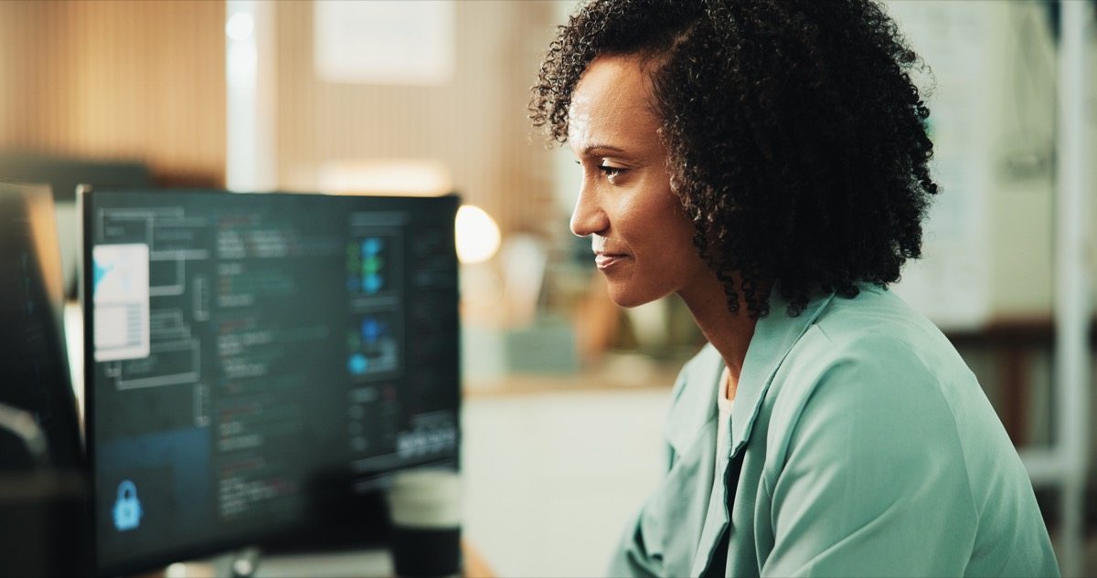 Developer working on website code at a desktop computer